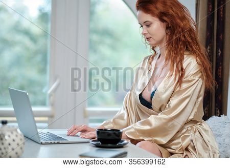Nice beautiful lady work at the notebook sit  at home - check on oline shops for cyber monday sales - technology woman concept for alternative office freelance. virus epidemic allert