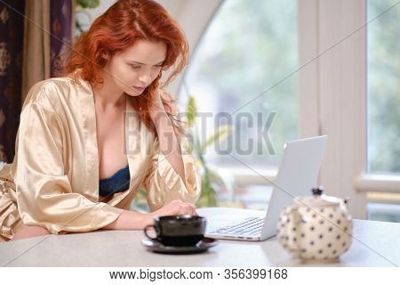 Nice beautiful lady work at the notebook sit  at home - check on oline shops for cyber monday sales - technology woman concept for alternative office freelance. virus epidemic allert