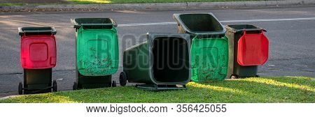 Australian Garbage Wheelie Bins Staying And Laying On A Kurb Side After Council Colleciton. Green Li
