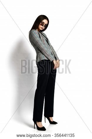 Stylish Sexy Brunette Woman Is Posing Sideways Holding Arms In Front Herself In Modern Office Pantsu