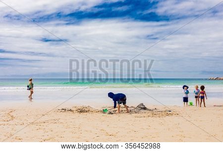 Kids Building Sand Castles On The Beach During School Holidays