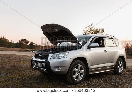Dnipro, Ukraine - February 19, 2020: Toyota Rav4 2006 Gray Color With Open Hood Near The Forest, Ope