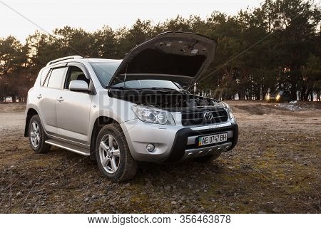 Dnipro, Ukraine - February 19, 2020: Toyota Rav4 2006 Gray Color With Open Hood Near The Forest, Ope