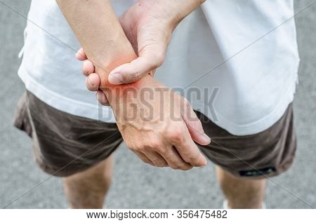 Wrist Pain. Male Holding Hand To Spot Of Wrist Pain.