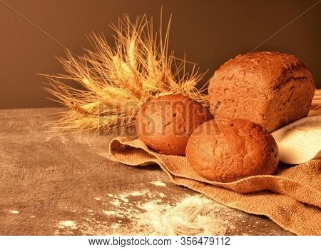 Rosy, Appetizing Bread, White Flour And Ripe Ears Of Wheat On A Jute Bag