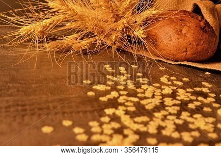 Rosy, Appetizing Bread, Small Pasta And Ripe Ears Of Wheat On A Jute Bag