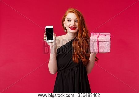 Portrait Of Excited And Amused Smiling, Wondered Redhead Woman Didnt Expact Receive Gift So Fast, Sh