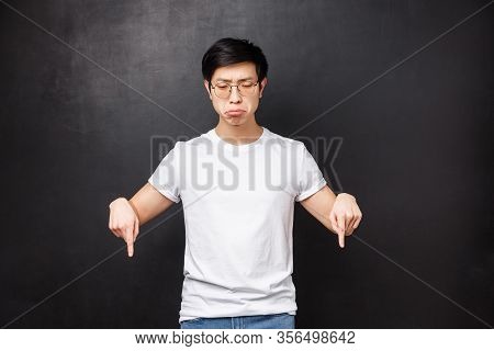 Whining And Sobbing Miserable Upset Asian Guy Feel Gloomy, Grimacing Uneasy And Distressed, Looking 