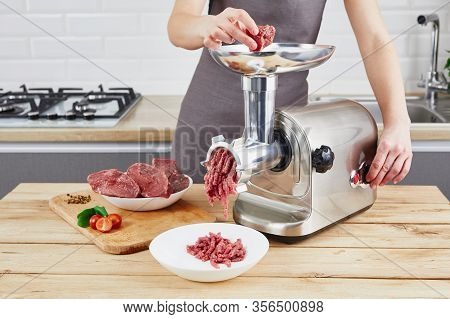 Raw Meat. The Process Of Preparing Forcemeat By Means Of A Meat Grinder. Female Hands Use Meat Chopp