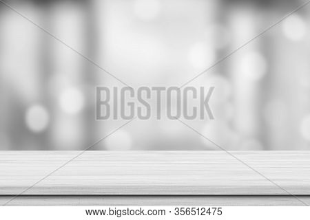 White Wood Tabletop Over Blur White Bokeh Light Background. Empty Wood Shelf For Product Display, Ba