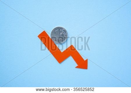 One Rouble Coin On Blue Background With Red Arrow Down. Exchange Rate Chart. Ruble Depreciation. Exc