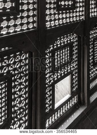 Black And White Angle View Of Interleaved Wooden Ornate Windows - Mashrabiya - In Abandoned Building