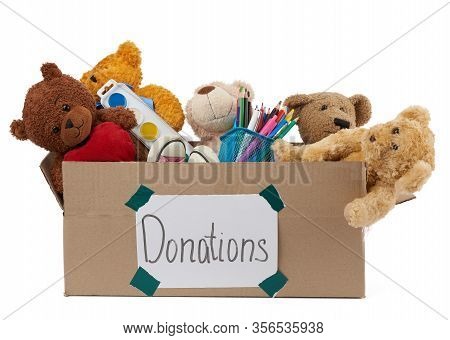 Brown Cardboard Box Filled With Soft Toys, School Supplies Isolated On White Background, Concept Of 