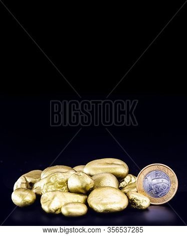 One Real Coin, With Gold Nuggets. Concept Of Devaluation Of The Brazilian Currency Or Stock Exchange