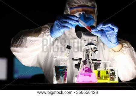 Chemical Laboratory, Man Conducts An Experiment. Analysis Drugs Based On Natural Raw Materials Plant