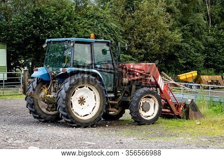 Tyndrum, Scotland - August 1, 2020: New Holland T5060 Tractor With Chilton Loader At The Farm And Ca