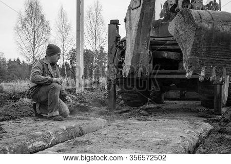 The Excavator Installs Concrete Slabs For The Road.