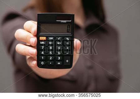 Calculator With Zero On The Display In Business Lady Hands Close Up.