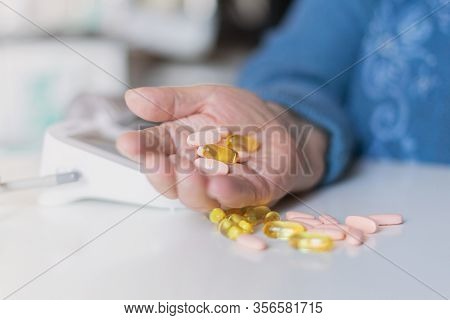 Elderly woman with pills hand, grandmother with medicines