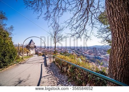 On The Hill Schlossberg With Tower Uhrturm In Deserted Town Graz, Styria At Virus Quarantine In Spri