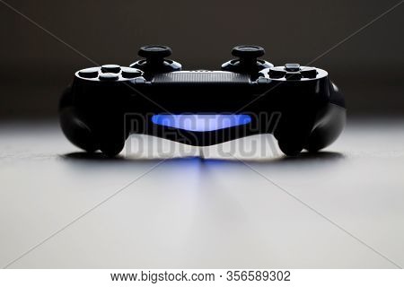 Brecht, Belgium - Februari 1 2020: A Frontal Dark Close Up Portrait Of A Turned On Playstation 4 Con