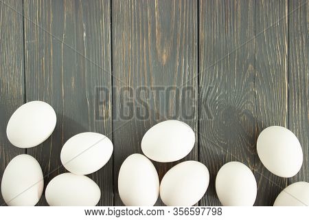 Easter. Chicken Eggs Of Natural Colors On A Wooden Background. Flat Lay