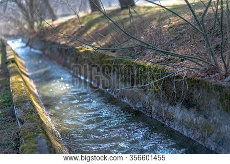 The River Flows In The Park Along The Canal