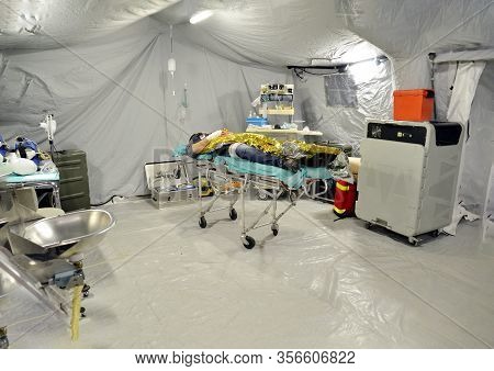 Lifeless Body Of A Person Inside A Hospital Field Tent For The First Aid, A Mobile Unit Of Red Cross