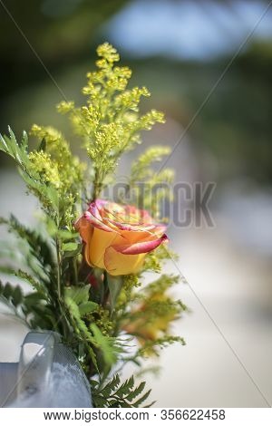 Yellow And Pink Rose With Soft Green Filler In The Background For A Wedding Decoratioin