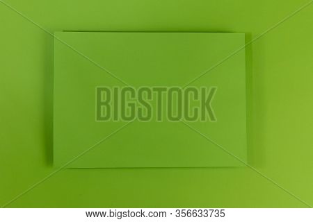Mosk Up. Abstract Green Paper Background. In The Center Of The Frame On A Green Surface Is A Green P