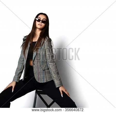 Stylish Brunette Woman In Modern Office Pantsuit Checkered Jacket, Black Trousers And Stylish Narrow