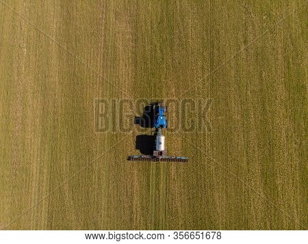 Tractor Applying Liquid Mineral Fertilizers To The Soil On Winter Wheat