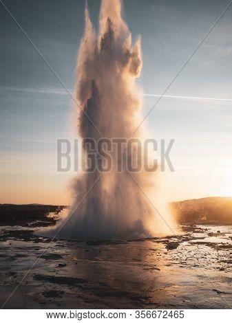 Famous Geysir In Iceland In Beautiful Sunset Light. One Of The Most Famous Natural Heritage On Icela