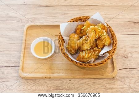 Padnoongo With White Sesame And Rice In A Container On A Wooden Tray And Condensed Milk On The Woode