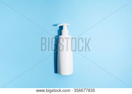 White Plastic Bottle On Blue Background. Mockup. Flat Lay. Sanitizer Gel For Prevention Of Virus. Co