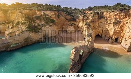 Aerial View Of Cliffs Blue Sea Water Beach Boiao, Portimao Portugal With Sun