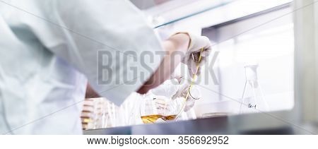 Female Scientist Working With Laminar Flow At Corona Virus Vaccine Development Laboratory Research F