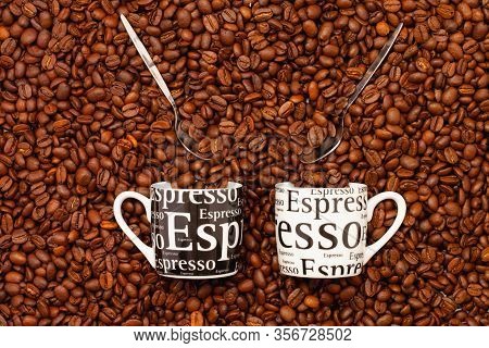 Two Cups Of Coffee On A Table Full Of Coffee Beans.  Coffee Design.