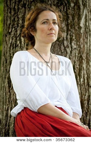 Young Woman In White Blouse Sitting