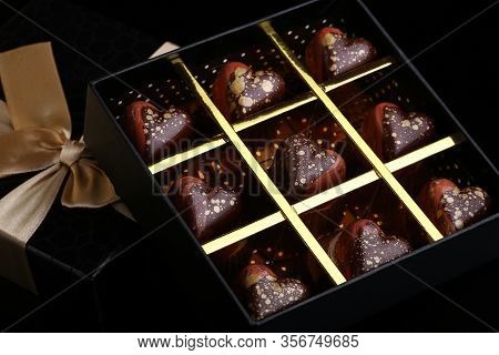 Heart Shaped Painted Luxury Handmade Bonbons In A Gift Box On A Black Background. Chocolates For Val