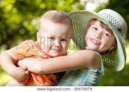 Girl Holds In Her Arms Her Brother