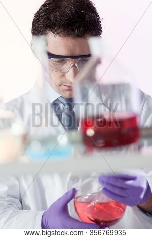 Chemist In Chemical Laoratory Searching For The Right Solution.