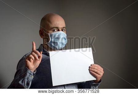 Man In Protective Face Mask With White Blank Sheet Poster Mockup