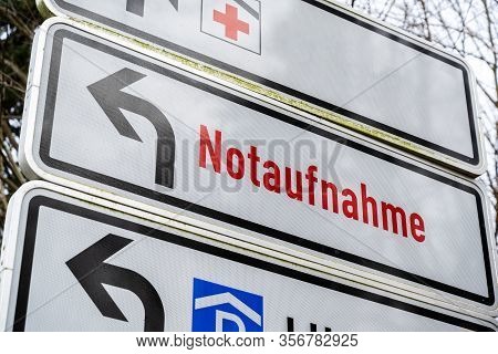 Direction Sign Shows German Text Notaufnahme, Meaning Emergency Department, At The Driveway To A Lar