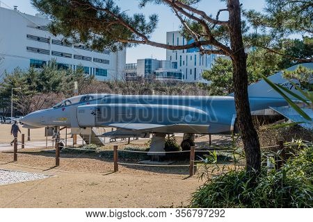 Daejeon, South Korea; March 16, 2020: Man Walking In Front Of Mcdonald Douglas Phantom F4 Jet Aircra