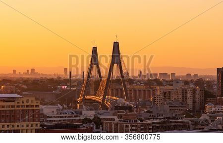 Close Up Aerial View Of Anzac Bridge In Sydney, During Sunset Time With Buildings In Background.  Th