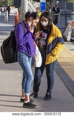San Ysidro, California, Usa - March 20, 2020: Two Young Hispanic Women Practice The Recommended Prec