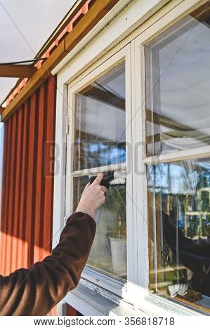 Cleaning Windows On A Cabin With A Machine