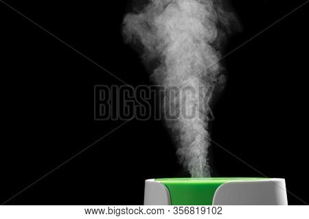 The Process Of Operation Of The Ultrasonic Humidifier Close-up. A Jet Of Steam Is Clearly Visible On