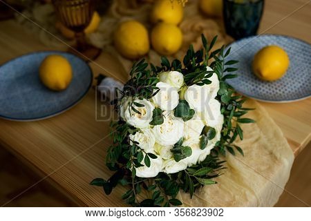 Wedding Bouquet Of White Roses On The Table